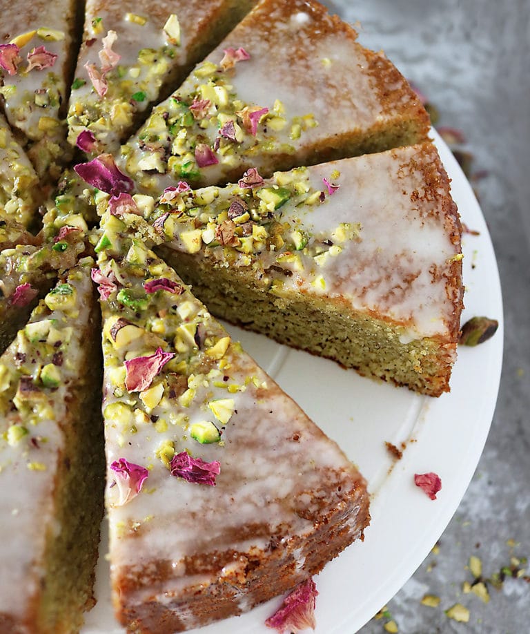 Overhead photo of Ottolenghi's Pistachio Rose Semolina Cake cut into slices