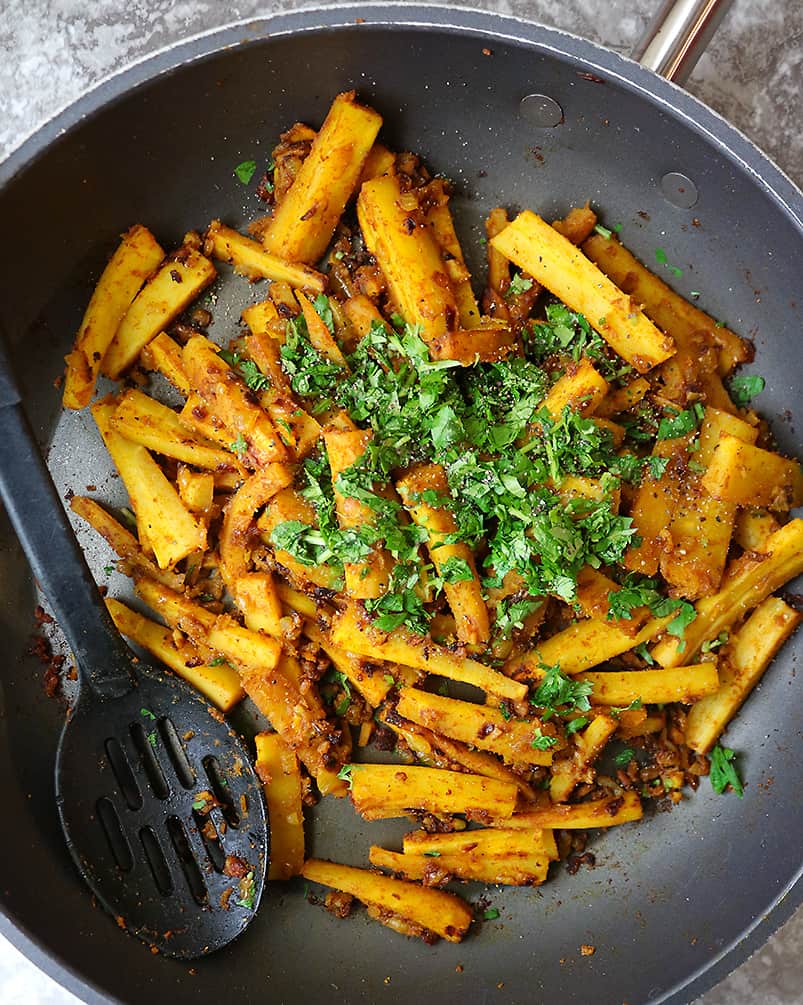 Sautéing parsnips and spices to make Golden Pan Roasted Parsnips
